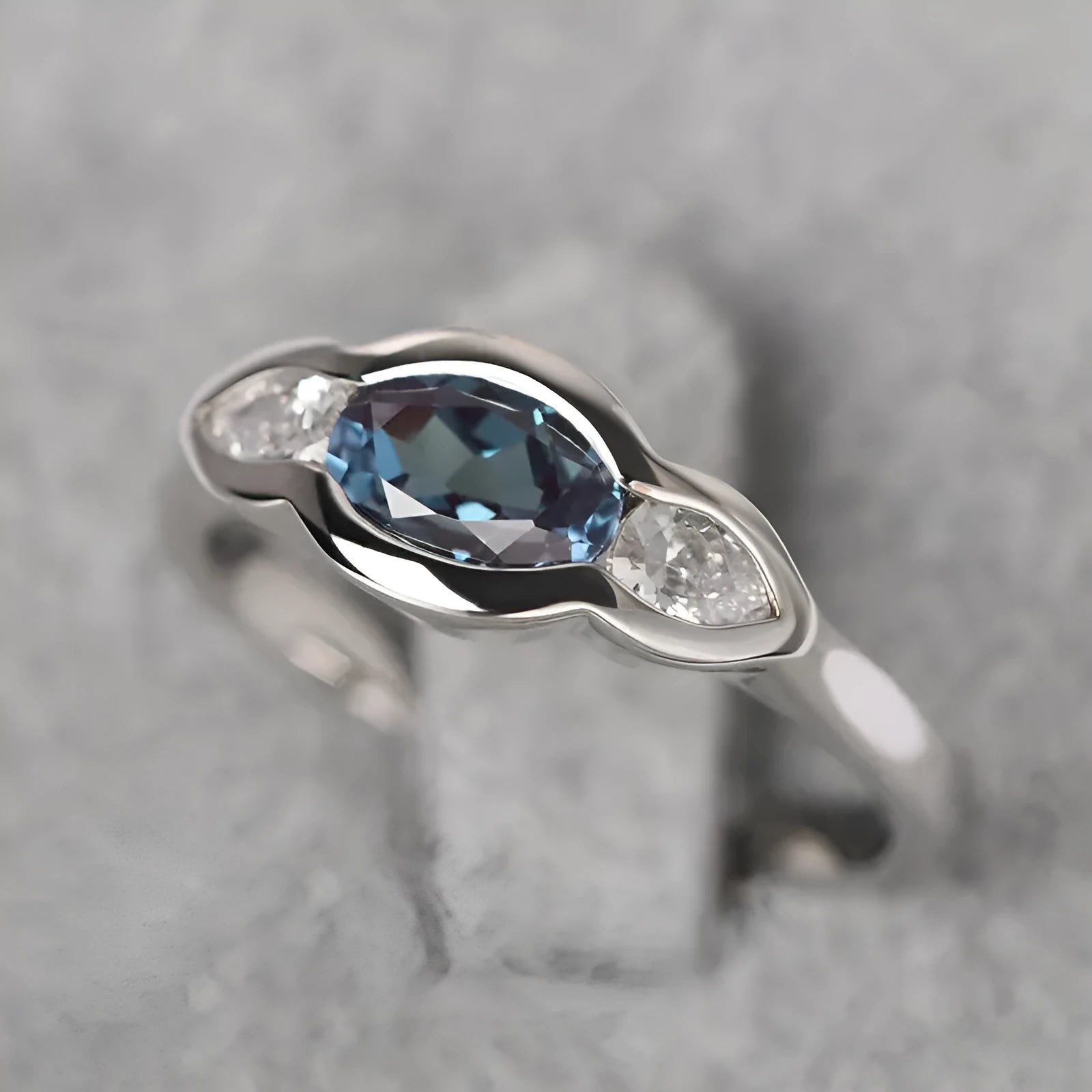 Geometric ellipse ring with zircon inlay in white gold colour on copper