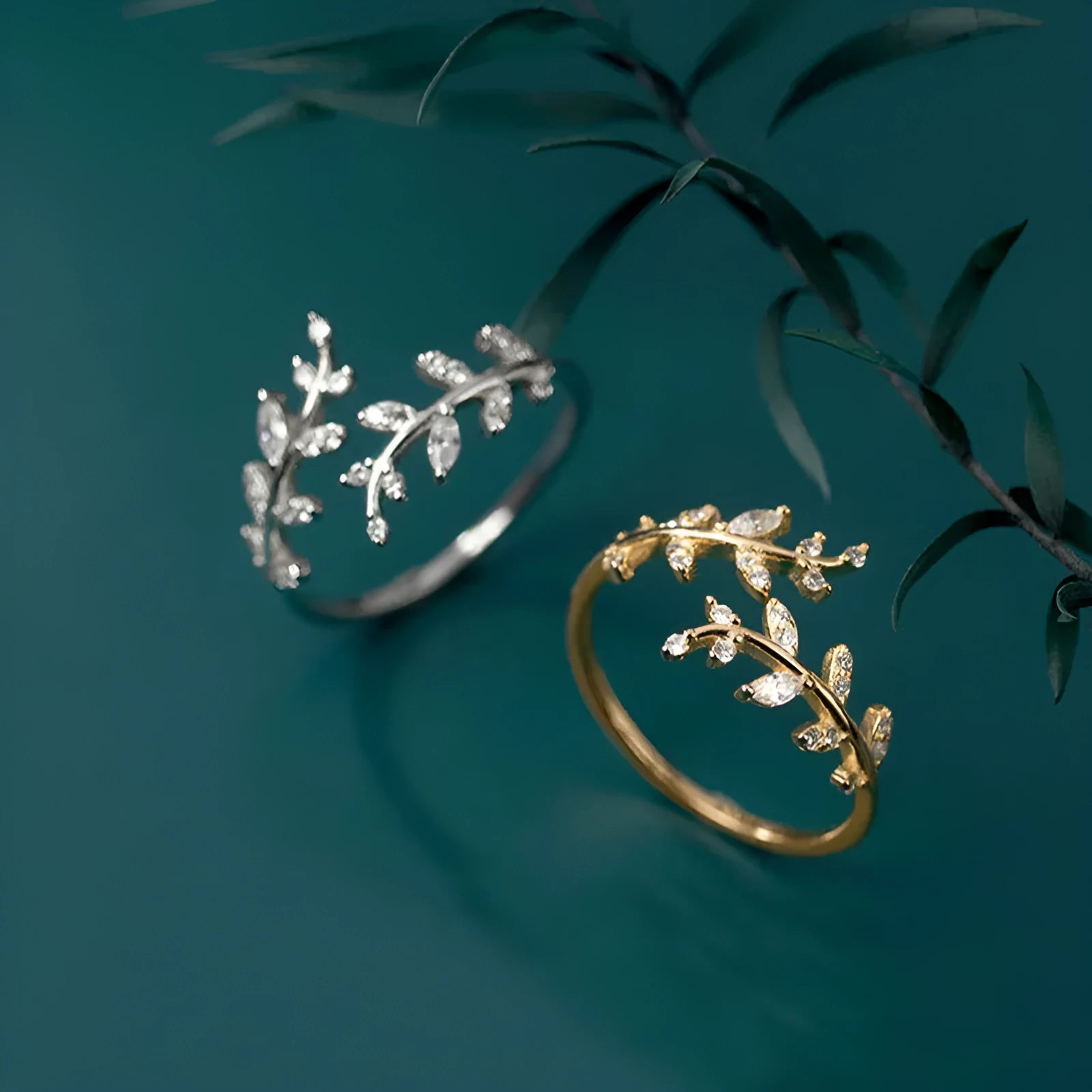 Gold and silver leaf-shaped branch ring for women on a white background.