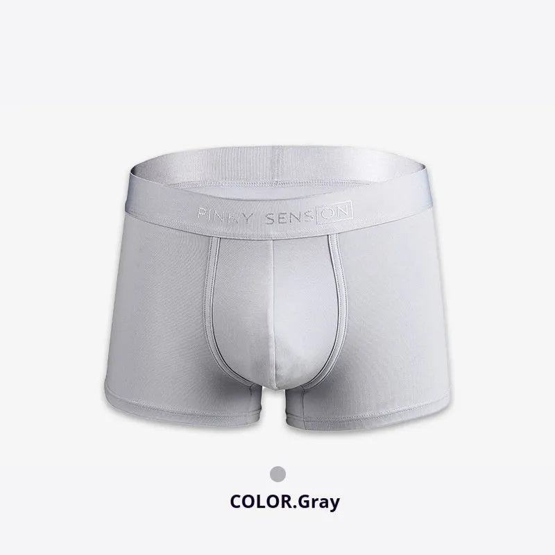 Men's solid colour cotton boxers in black, white, silver grey, and light green laid flat