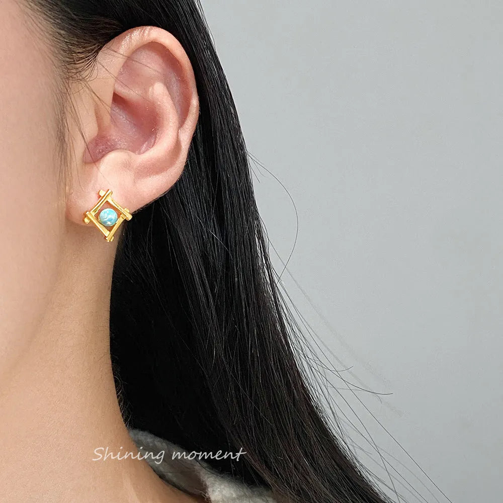 Geometric cross shaped stud earrings in sterling silver with angular design and gold or silver finish