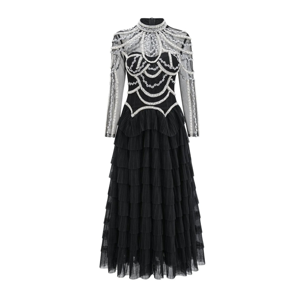 Black and pink women's long sleeve dress with beaded decoration on the front.