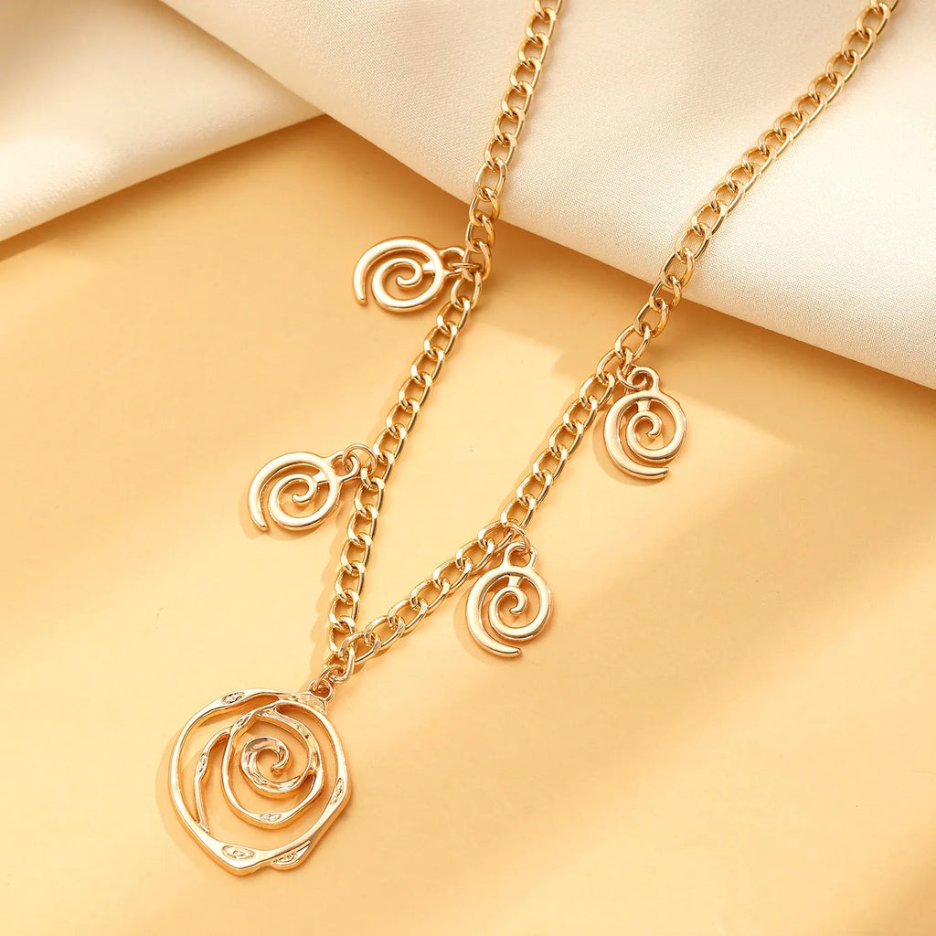 Women's spiral donut jewellery set showing bracelet, earrings, and adjustable necklace in gold tone