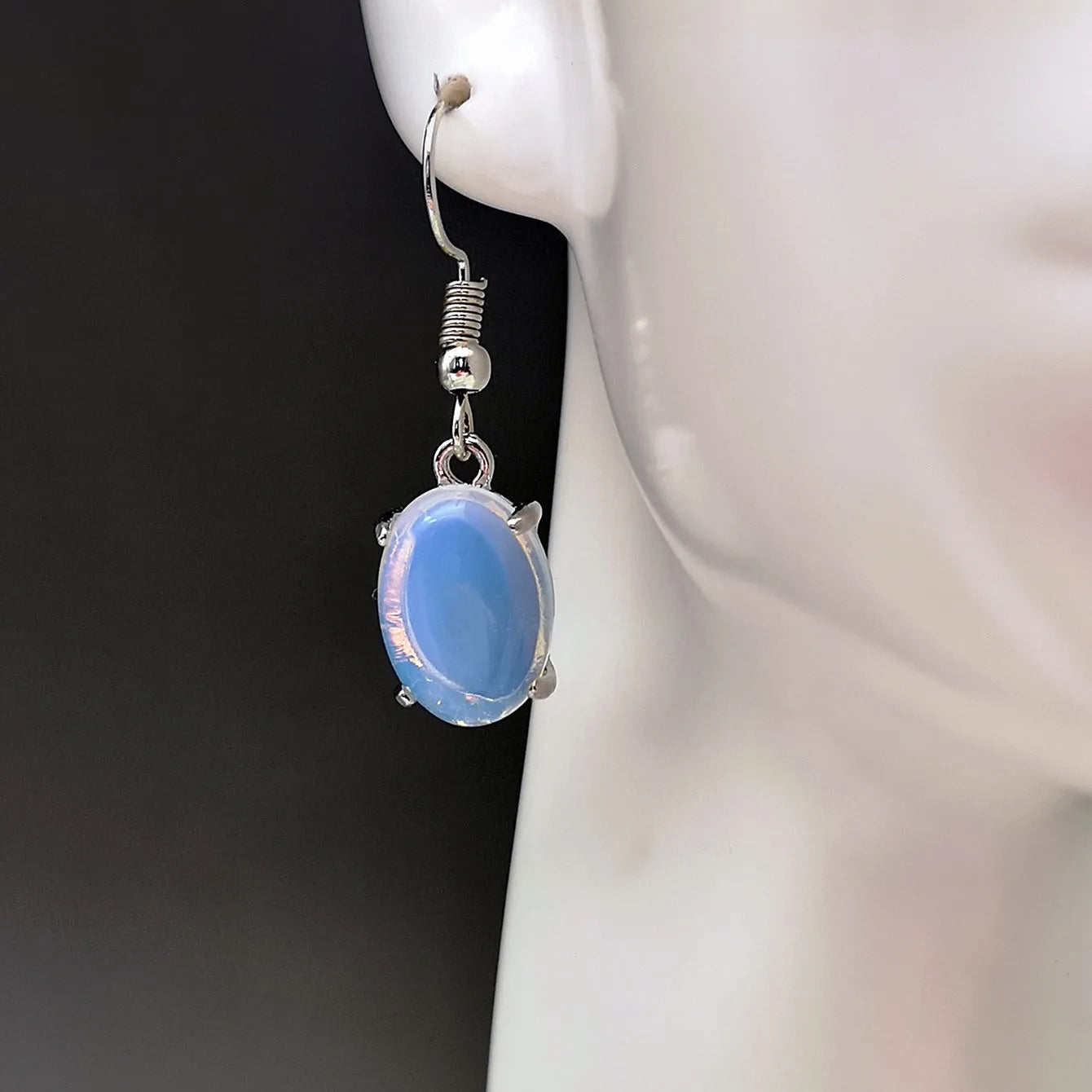 Retro moonstone opal earrings with cross design and drop-shaped elliptical pendants