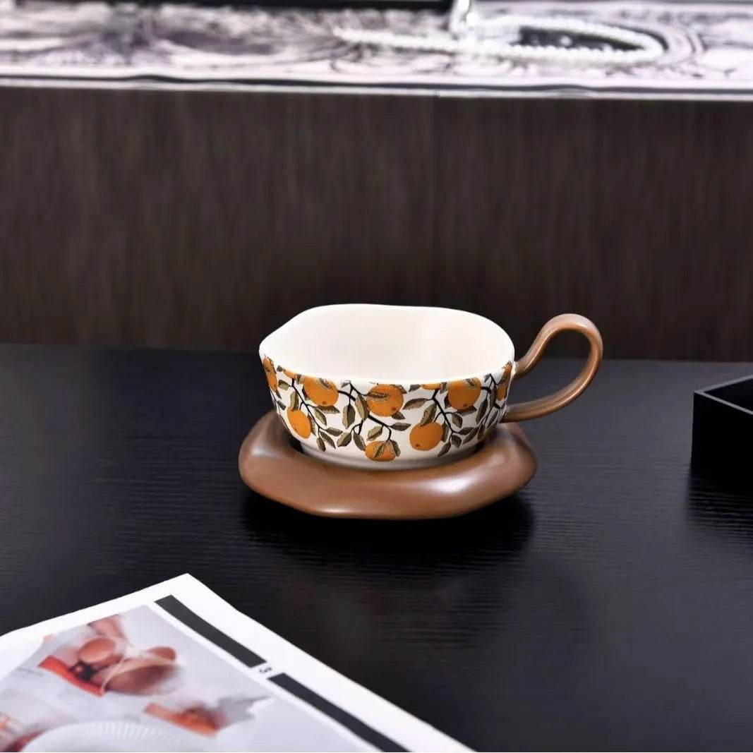 Antique style ceramic coffee cup and saucer set with medieval design in black or orange colour