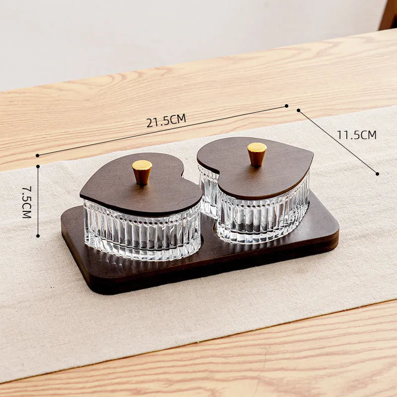 Transparent heart-shaped glass snack plate with multiple compartments and lids for organised food serving