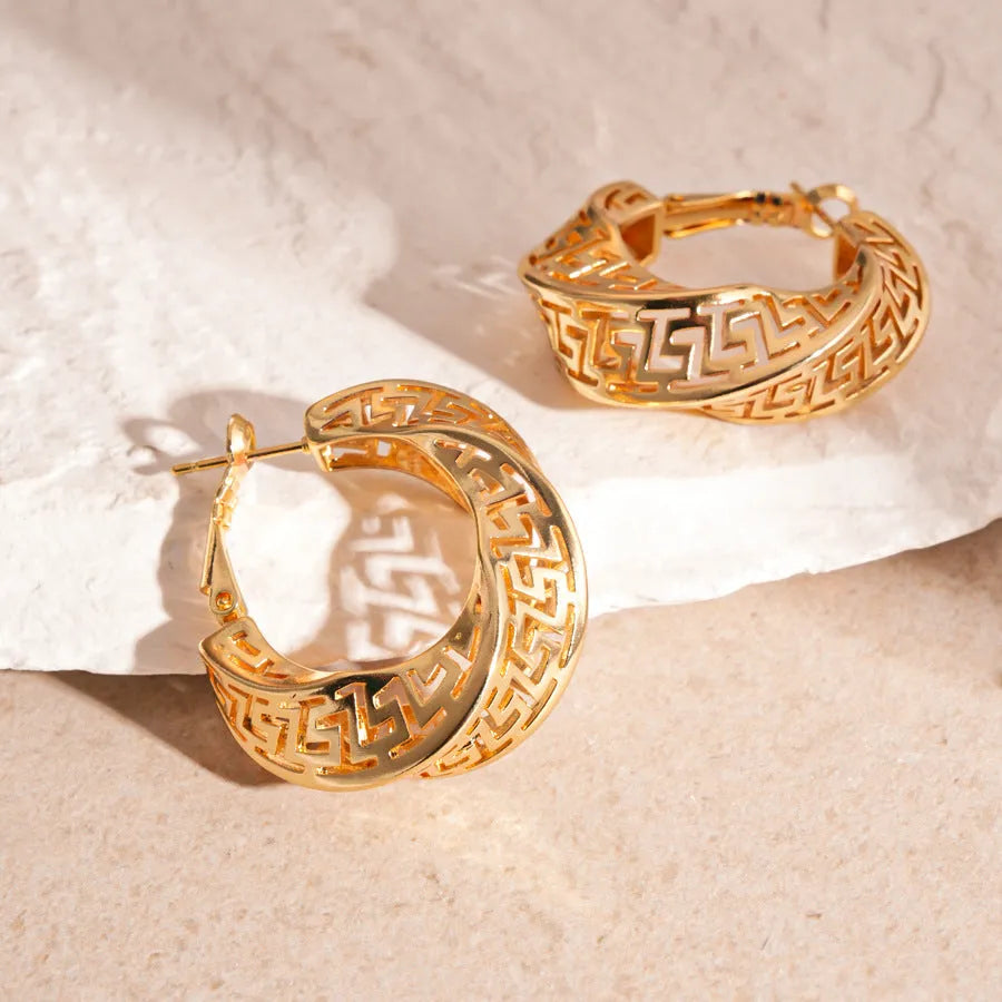 Women's geometric hollow stud earrings with twisted round design in gold and silver colour options