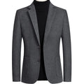 Men's slim fit wool suit jacket in grey, shown on a hanger, suitable for autumn and winter.