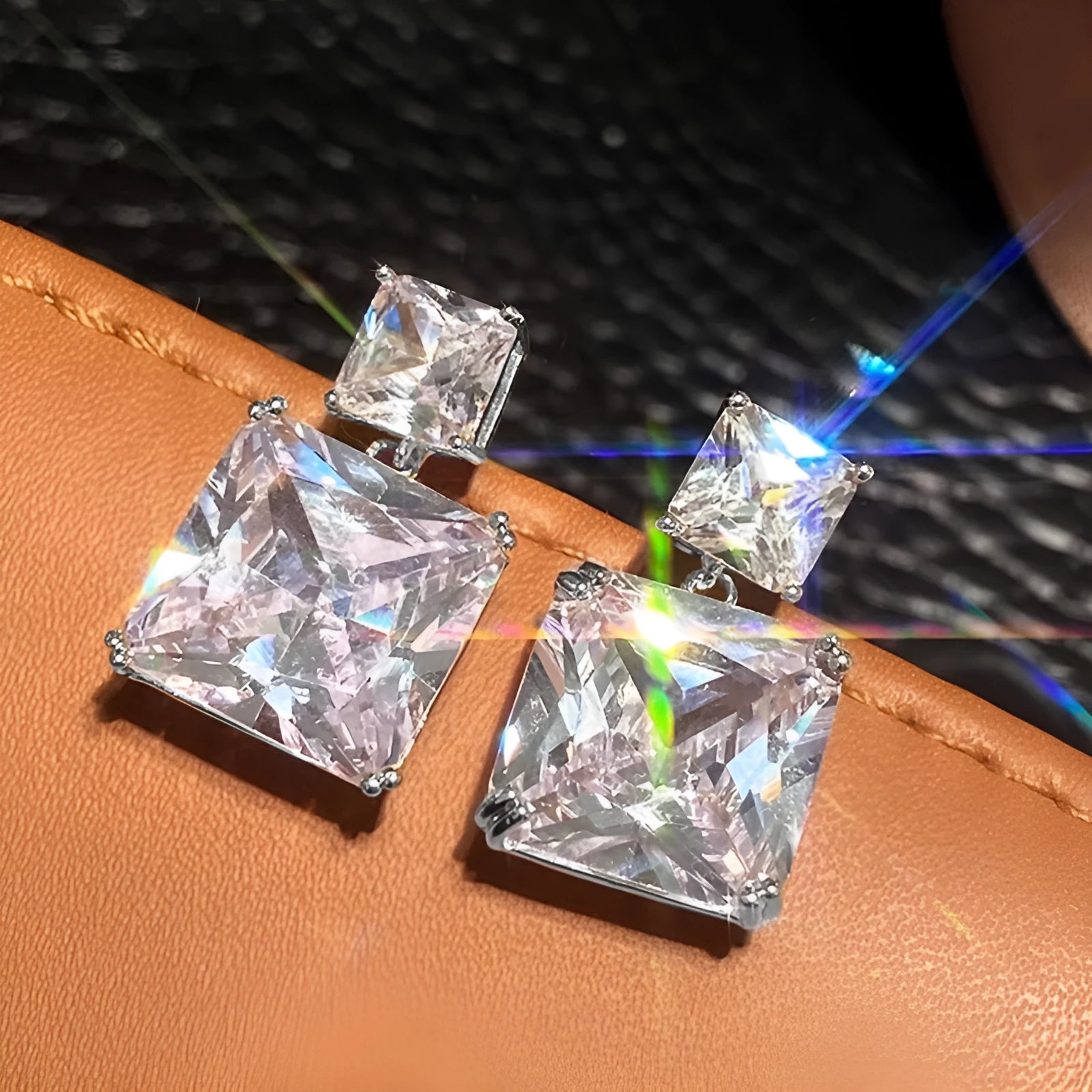 A pair of geometric square copper earrings for women, shown in white gold and gold colour finishes.