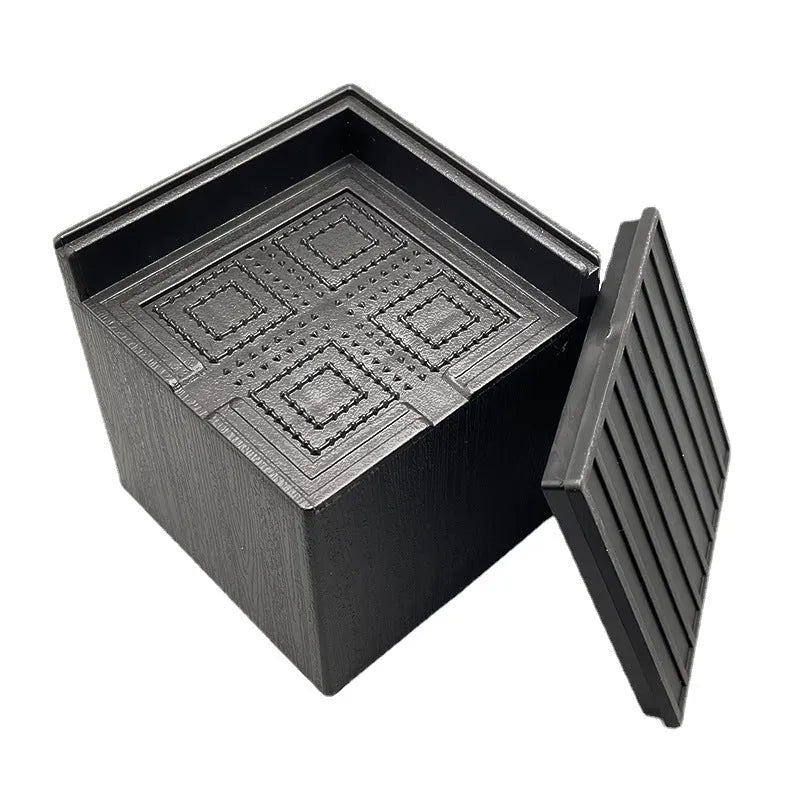 Four black plastic furniture riser feet for bed and sofa height adjustment