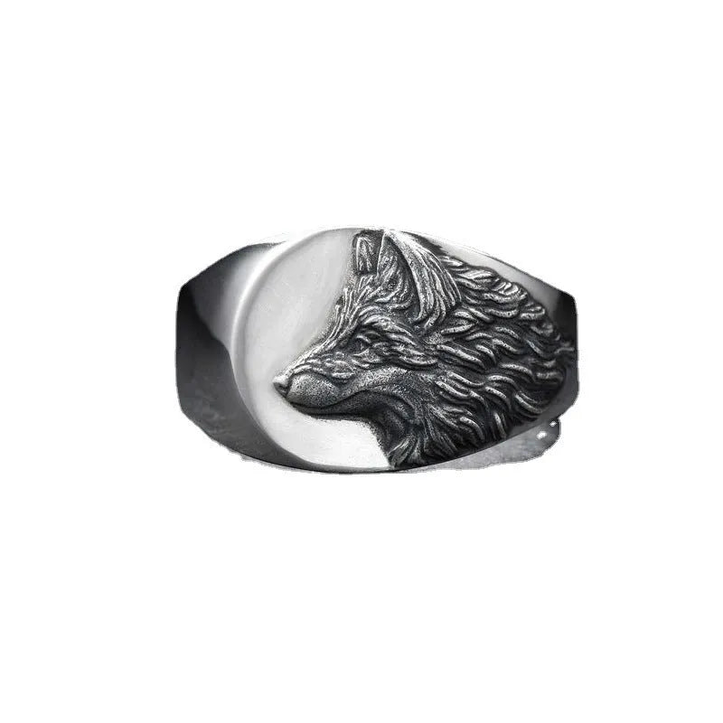Men's silver geometric wolf head ring on a grey background showing detailed alloy construction.