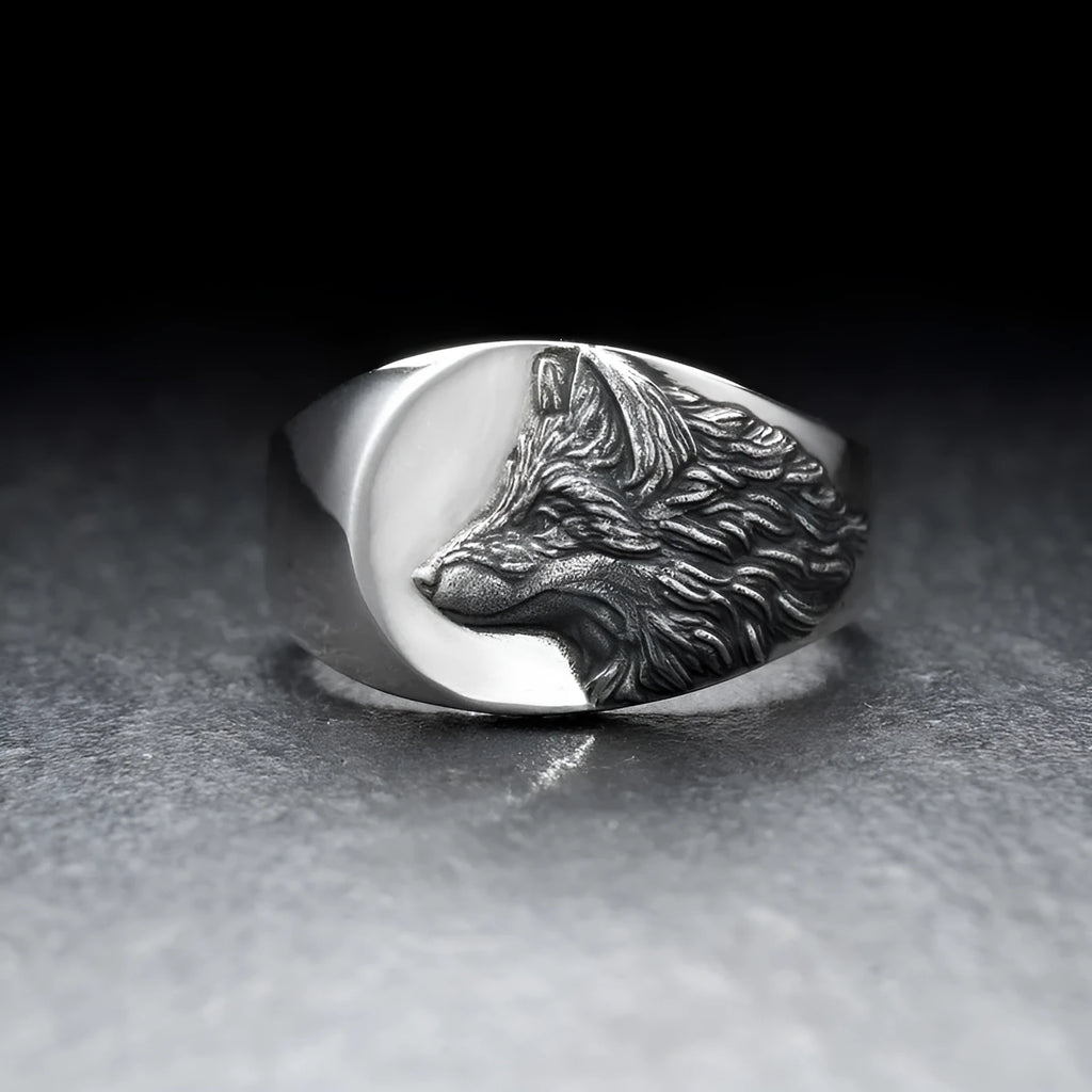 Men's silver geometric wolf head ring on a grey background showing detailed alloy construction.