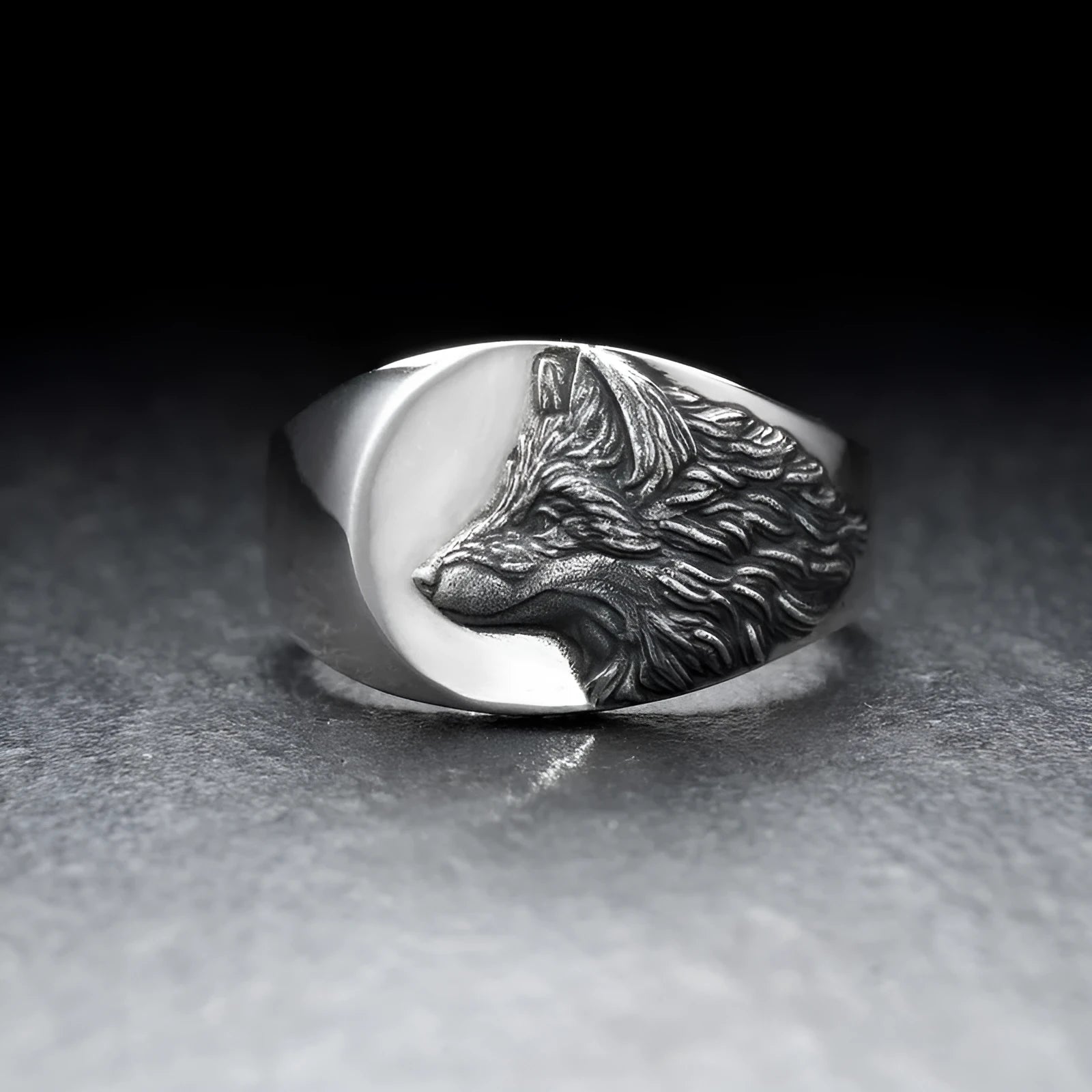 Men's silver geometric wolf head ring on a grey background showing detailed alloy construction.