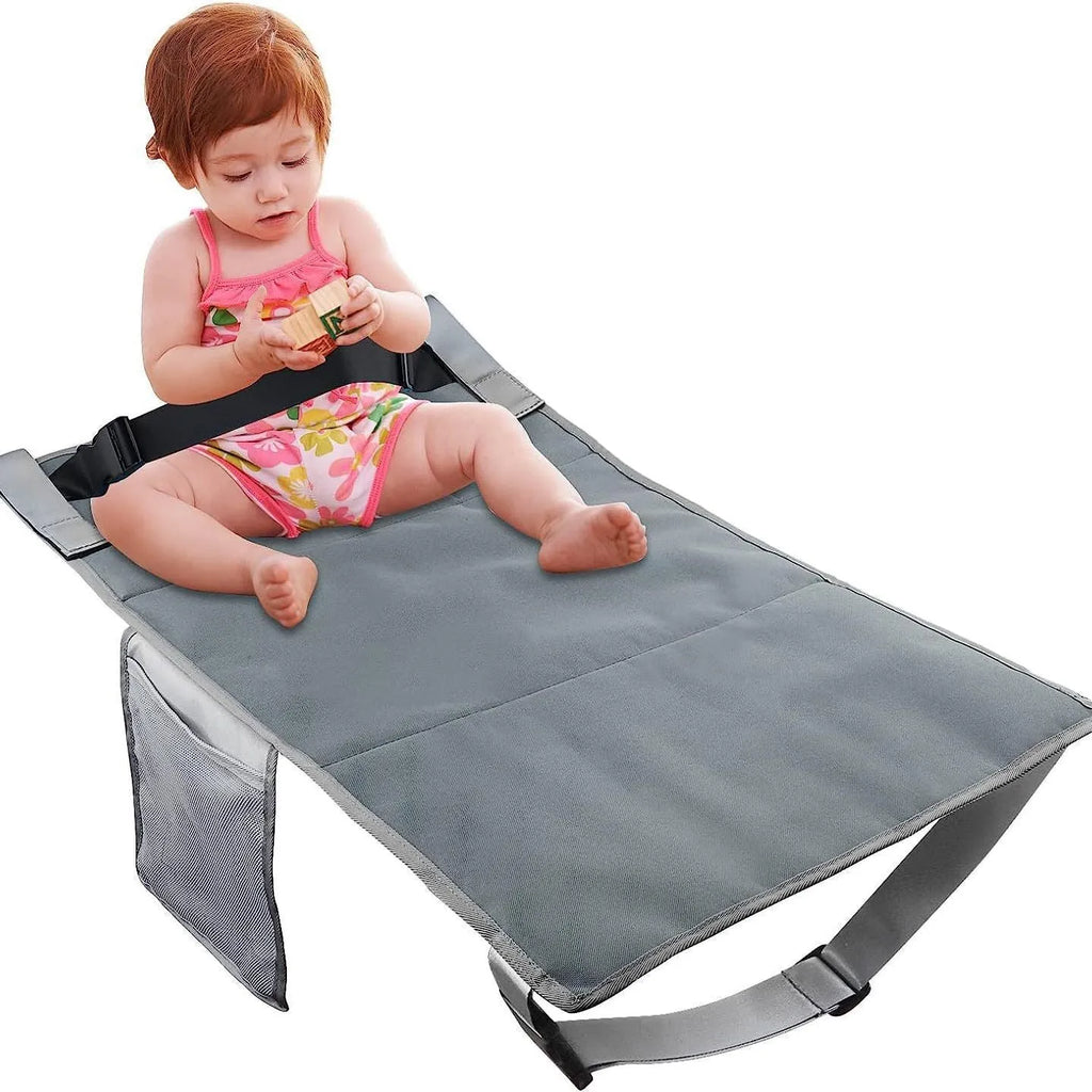 Portable grey nylon children's aircraft seat pedal extender with a matching drawstring pocket.