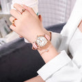 Women's automatic mechanical watch on wrist showing open case back with visible movement