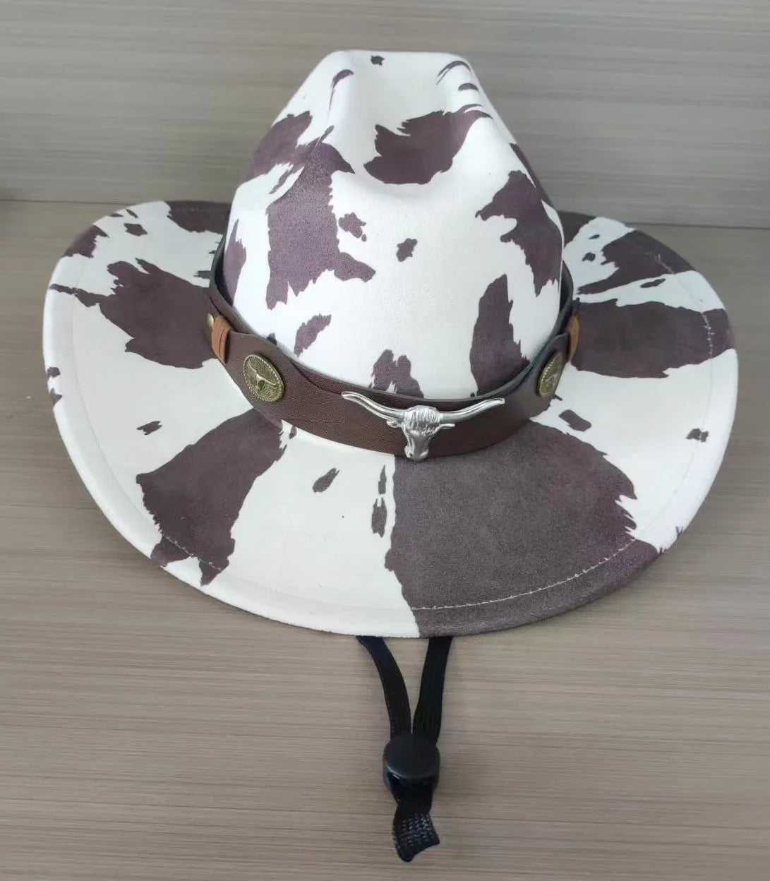 Brown leather velvet curved edge Western cowboy hat with a conical crown.