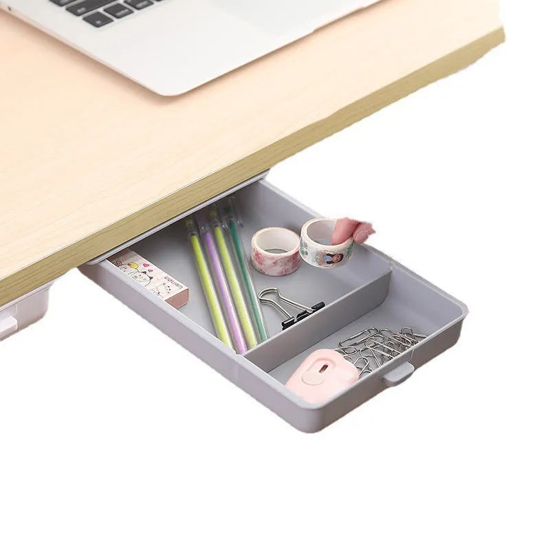 White plastic adhesive storage drawer with a covered grid design, shown mounted under a wooden desk.