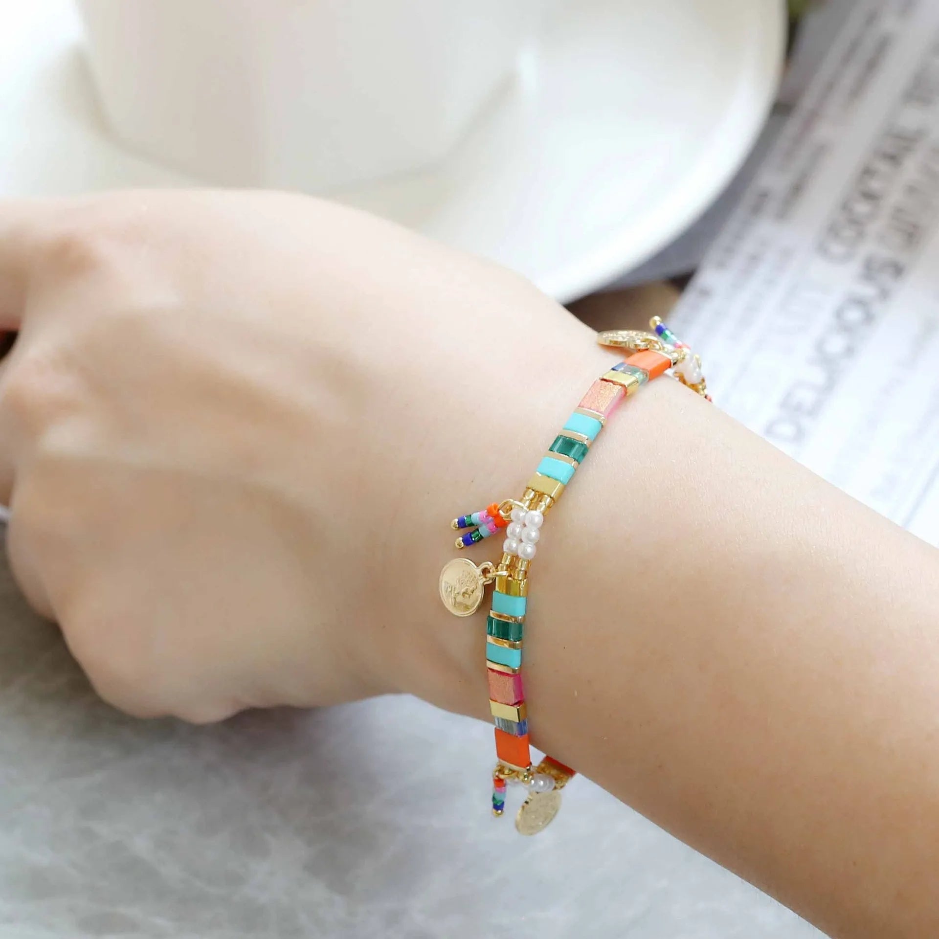 Women's imitation pearl beaded bracelet with glass coloured beads in six pearl lifting colour options