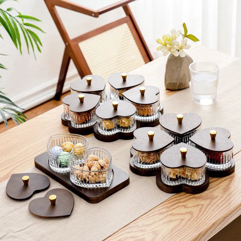 Transparent heart-shaped glass snack plate with multiple compartments and lids for organised food serving