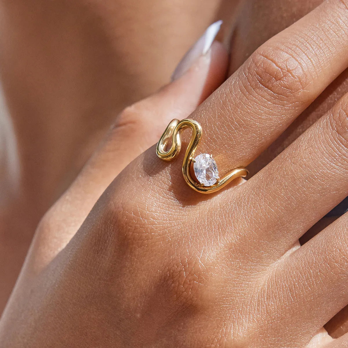 Geometric zircon ring in titanium steel with non-fading finish on a hand.