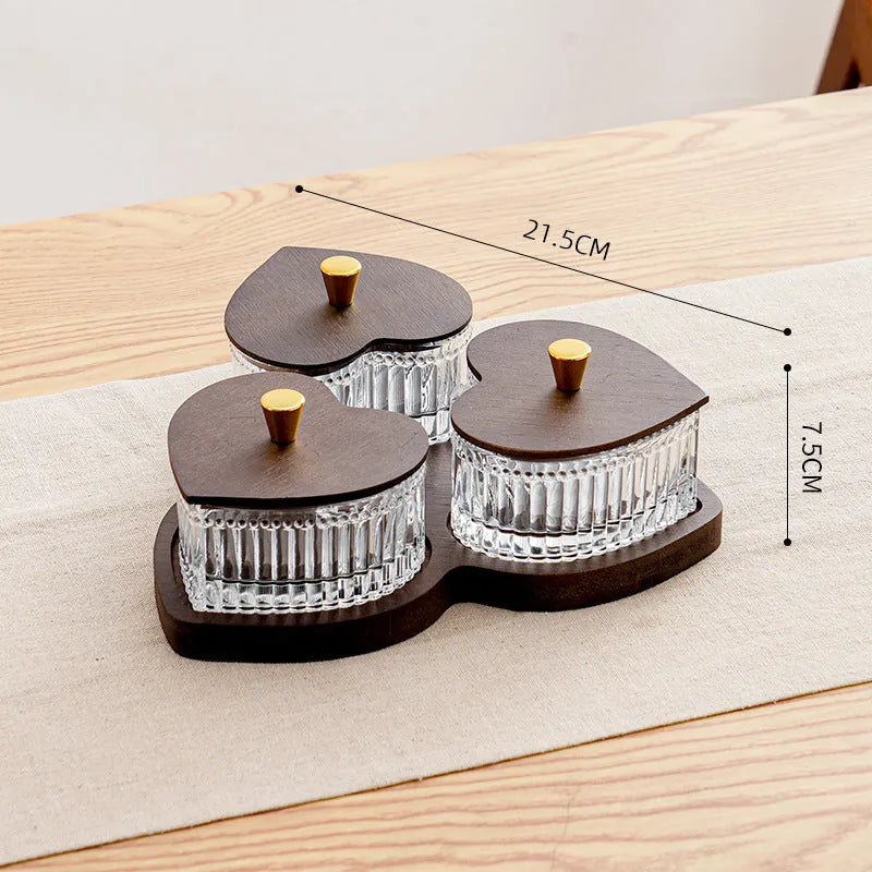 Transparent heart-shaped glass snack plate with multiple compartments and lids for organised food serving