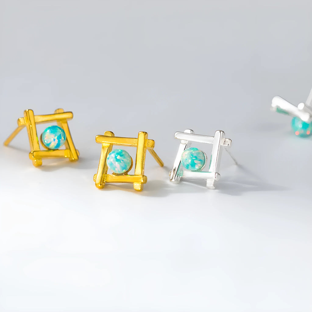 Geometric cross shaped stud earrings in sterling silver with angular design and gold or silver finish