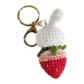 Hand-woven white doll wire pendant with cartoon rabbit and strawberry design on a key ring.