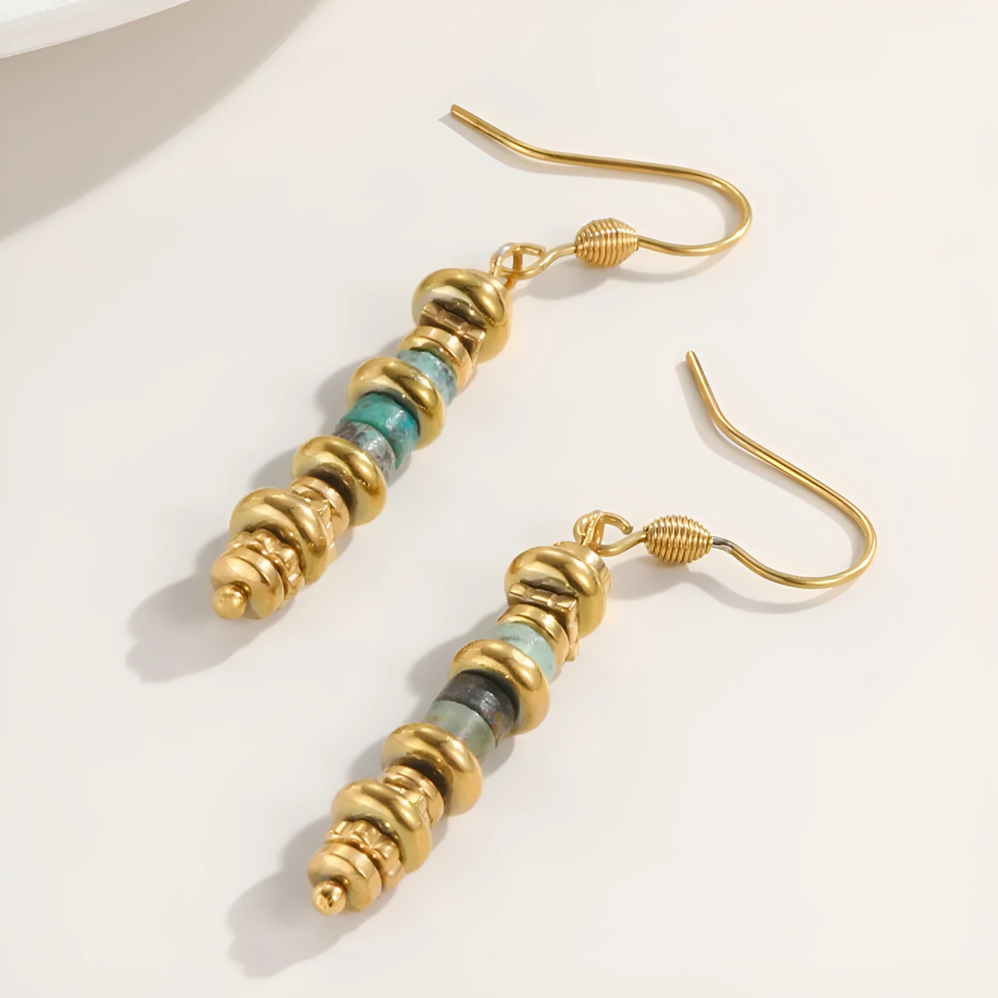 Pair of silver geometric-shaped titanium steel dangle earrings with an 18K gold finish.