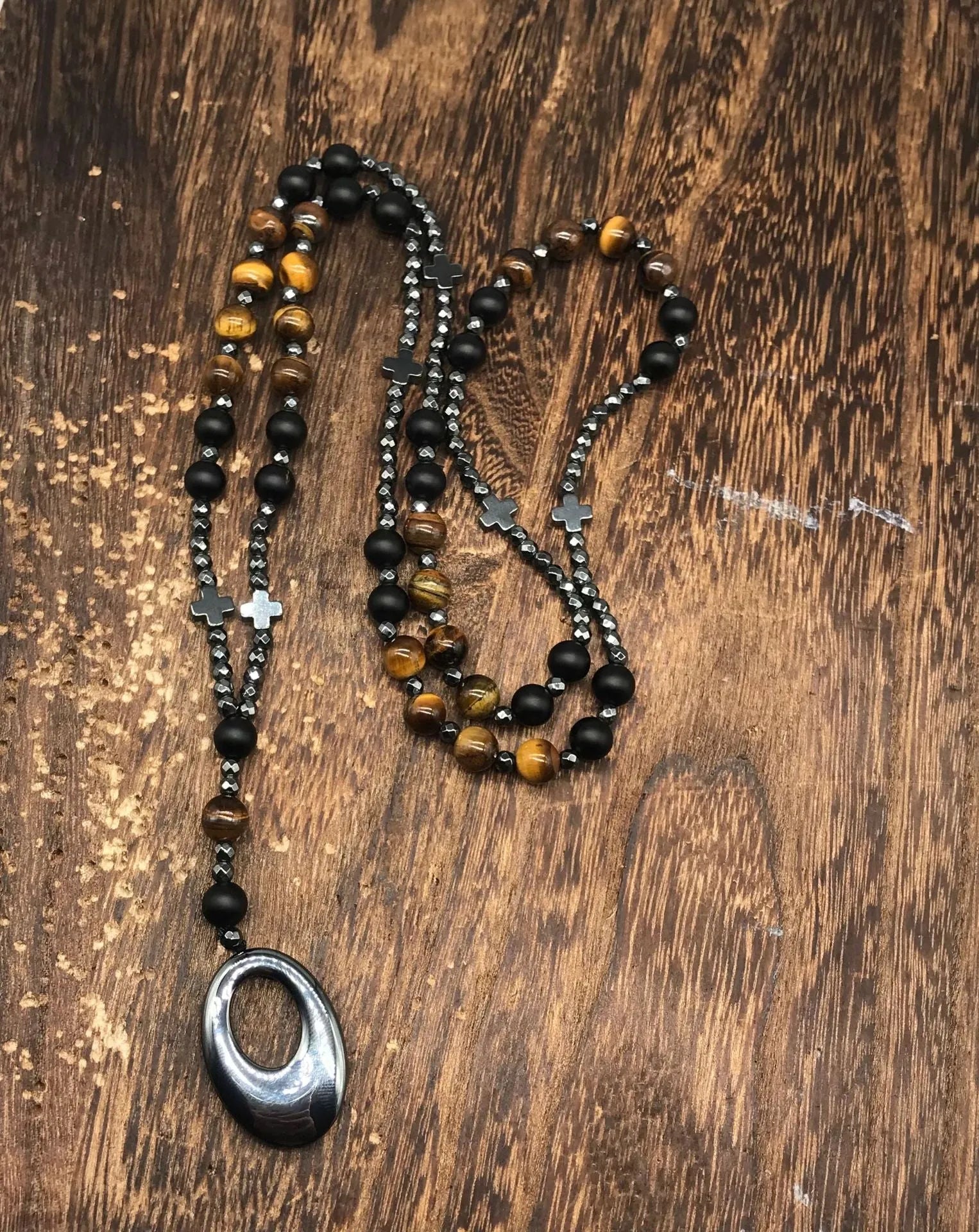 Men's stone cross pendant necklace on a ball bead chain with a safety lock clasp.