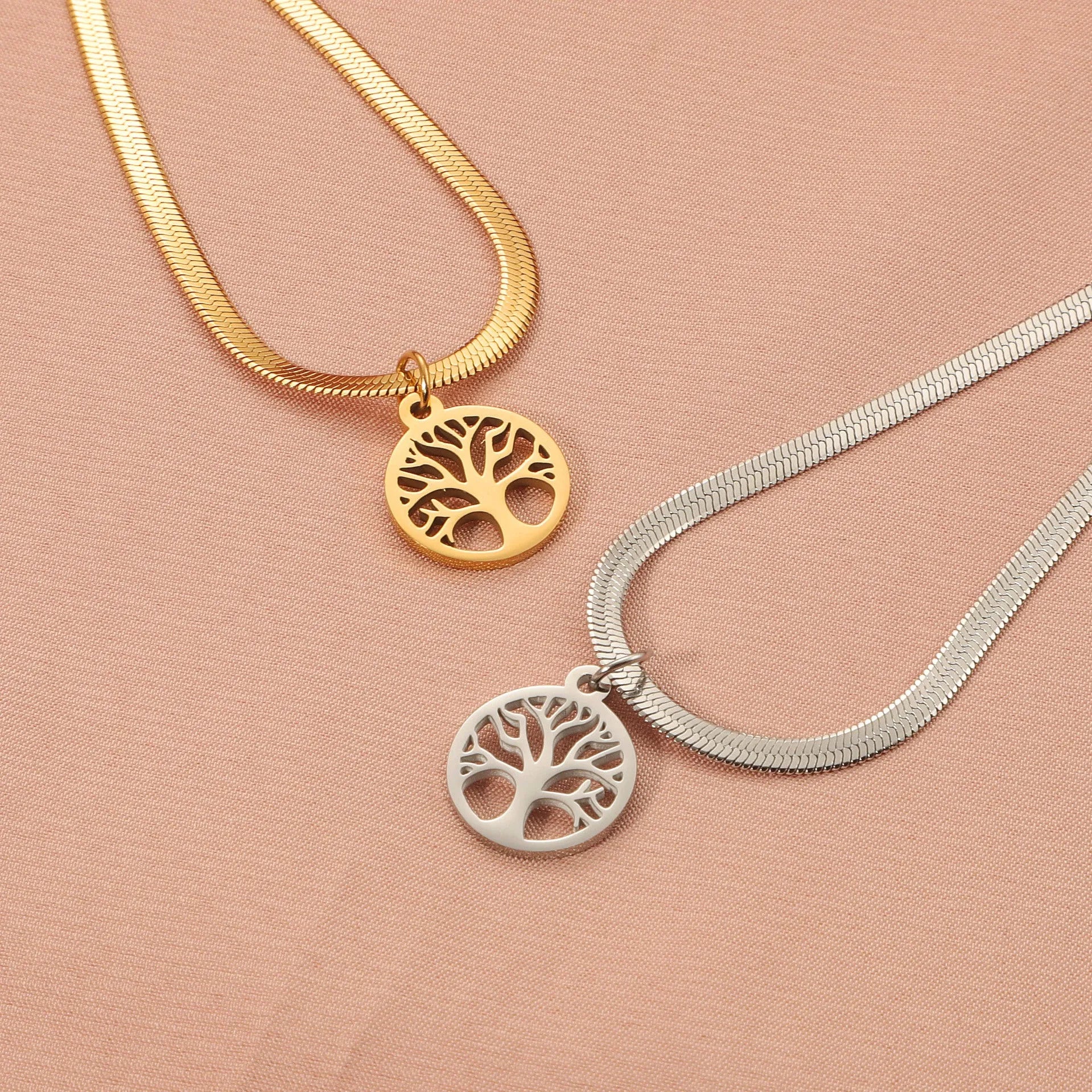 Stainless steel tree pendant necklace on a textured snake bone chain, shown in gold colour.