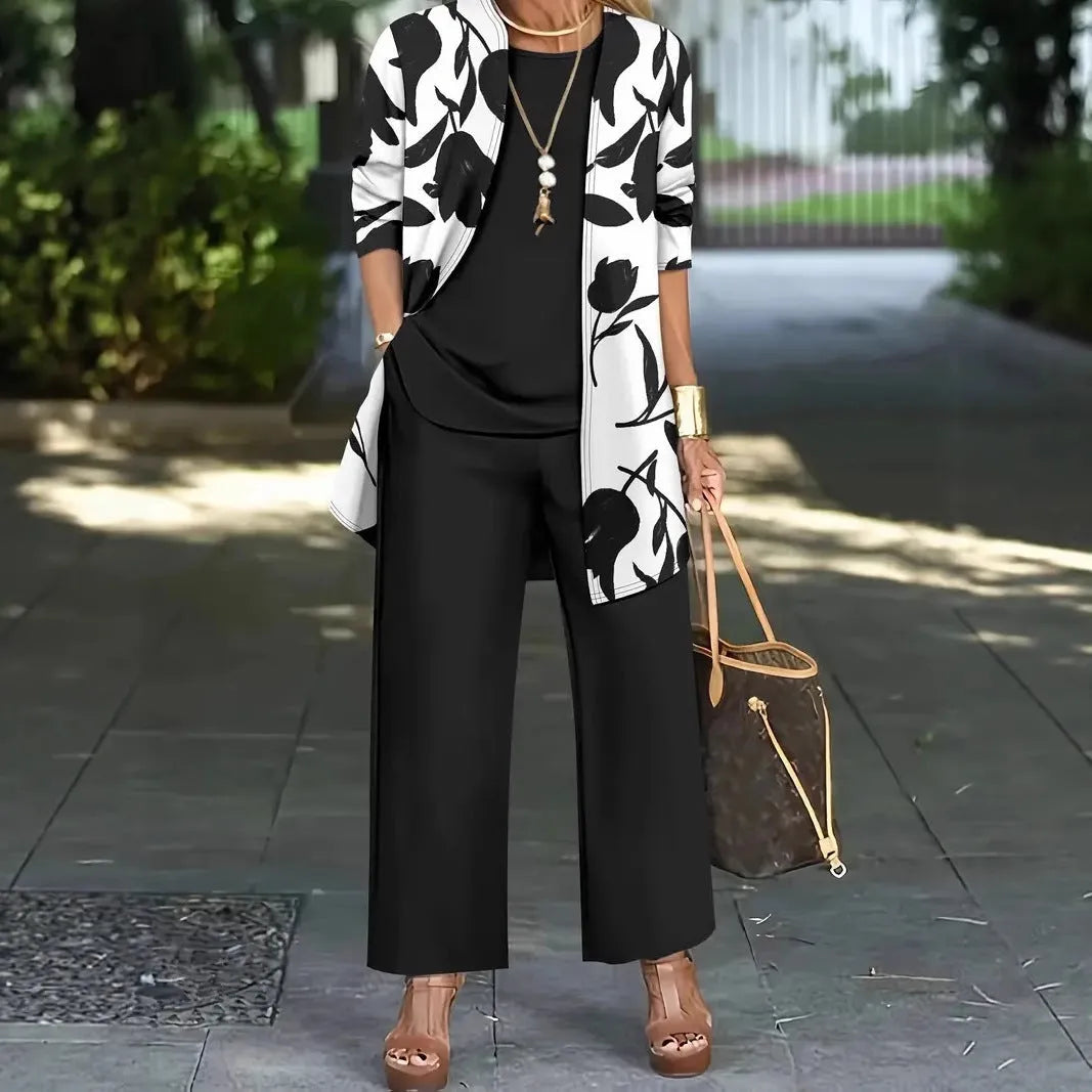 Women's blue three-piece casual suit featuring a long-sleeve coat, a vest, and full-length trousers.