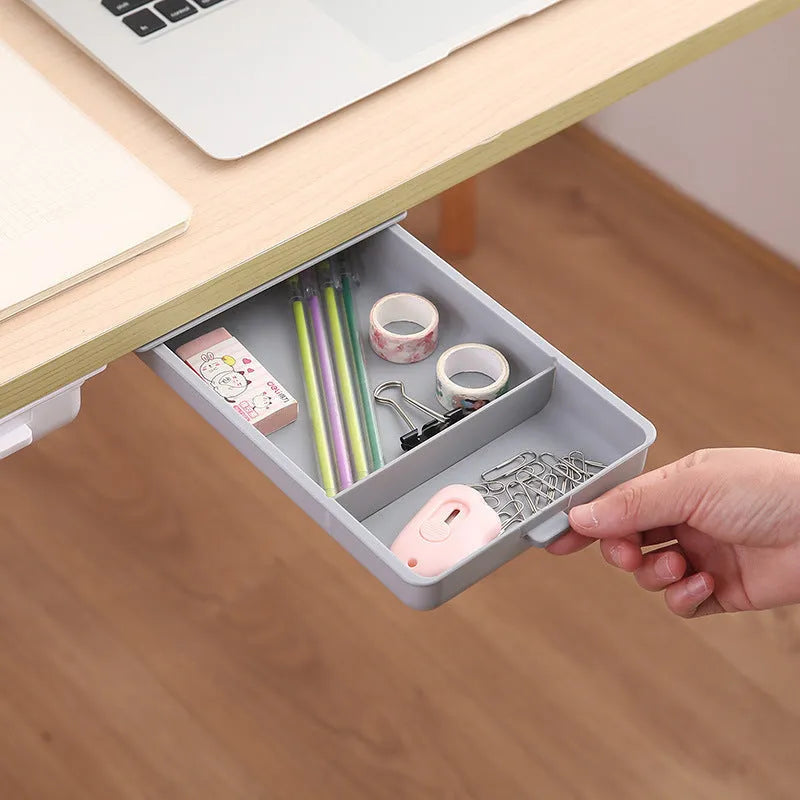White plastic adhesive storage drawer with a covered grid design, shown mounted under a wooden desk.