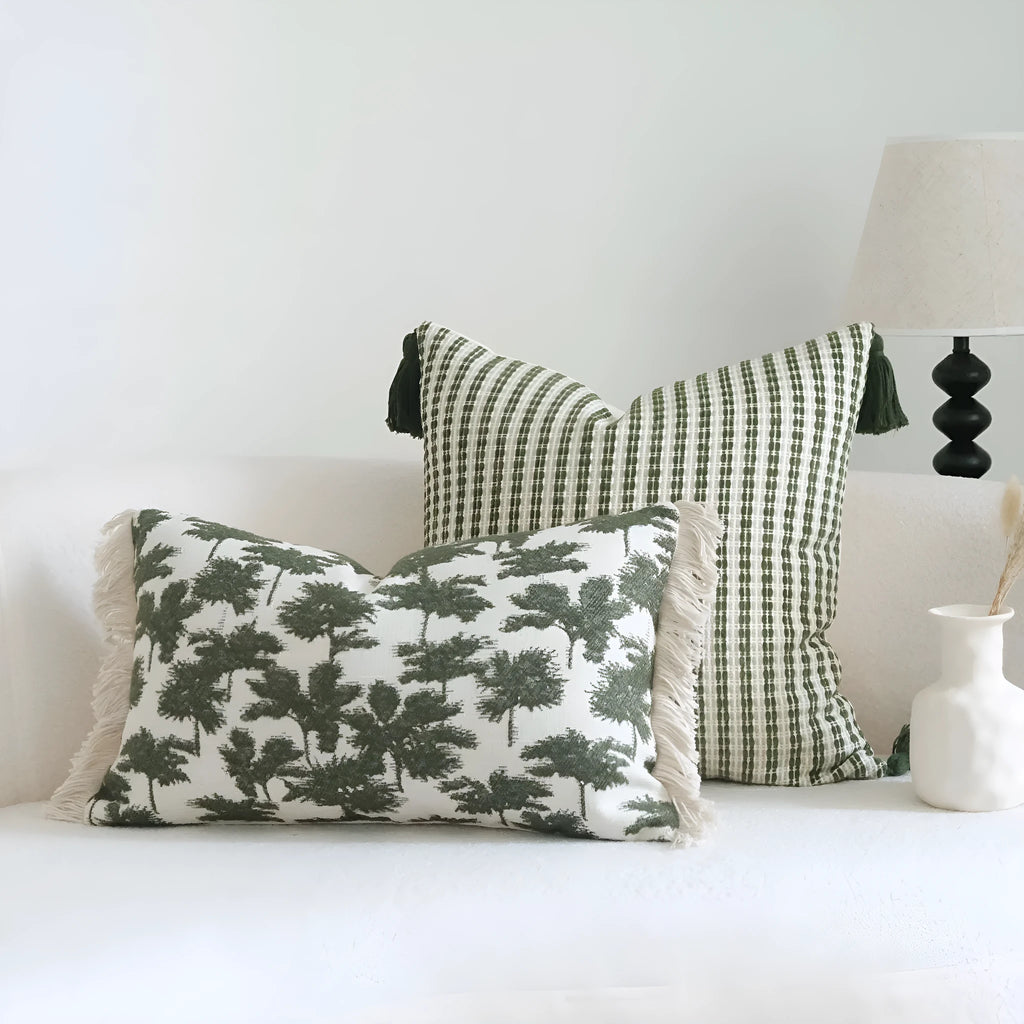 Green cotton and linen hotel sample pillow with botanical pattern and tassel trim