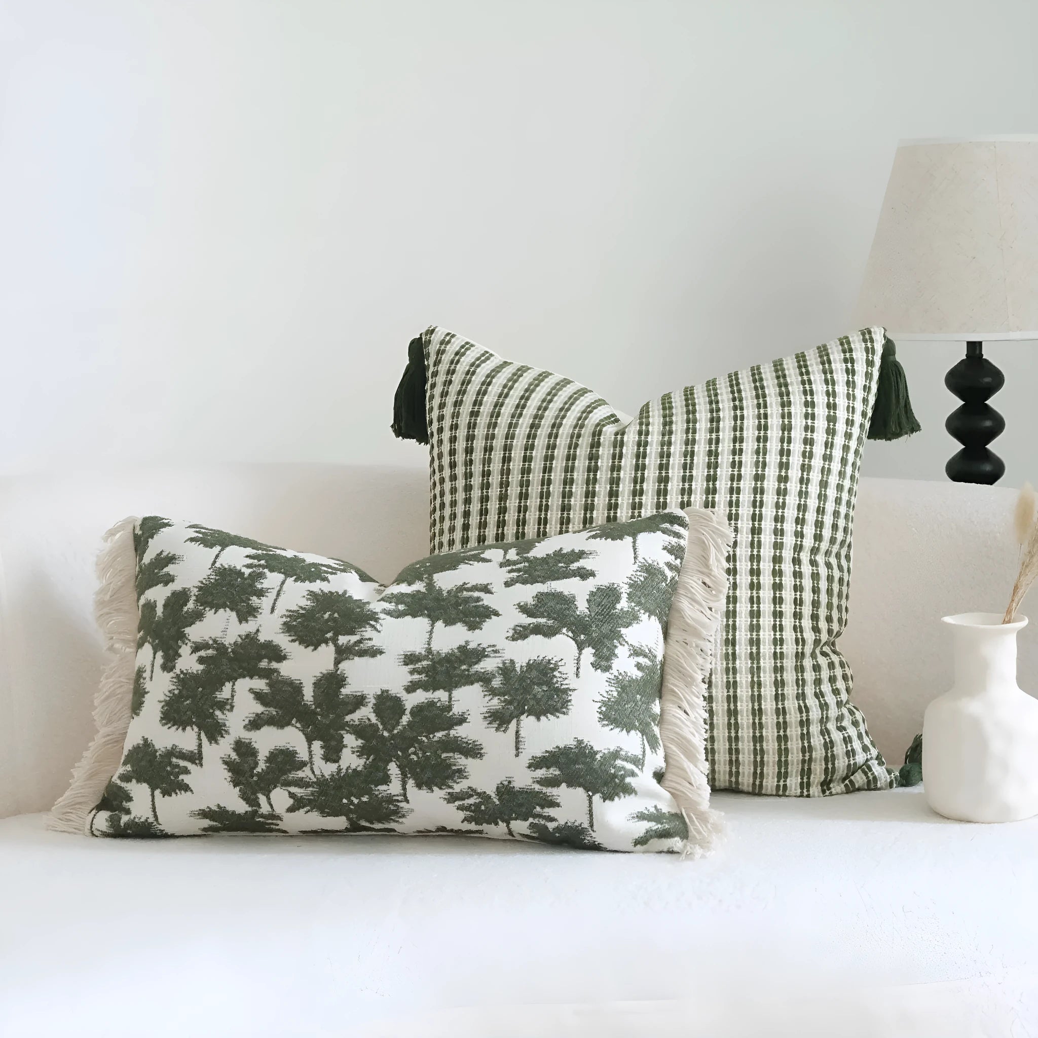 Green cotton and linen hotel sample pillow with botanical pattern and tassel trim
