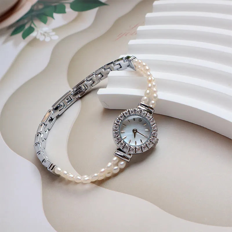 Women's light gold bracelet watch with freshwater pearl dial and stainless steel strap