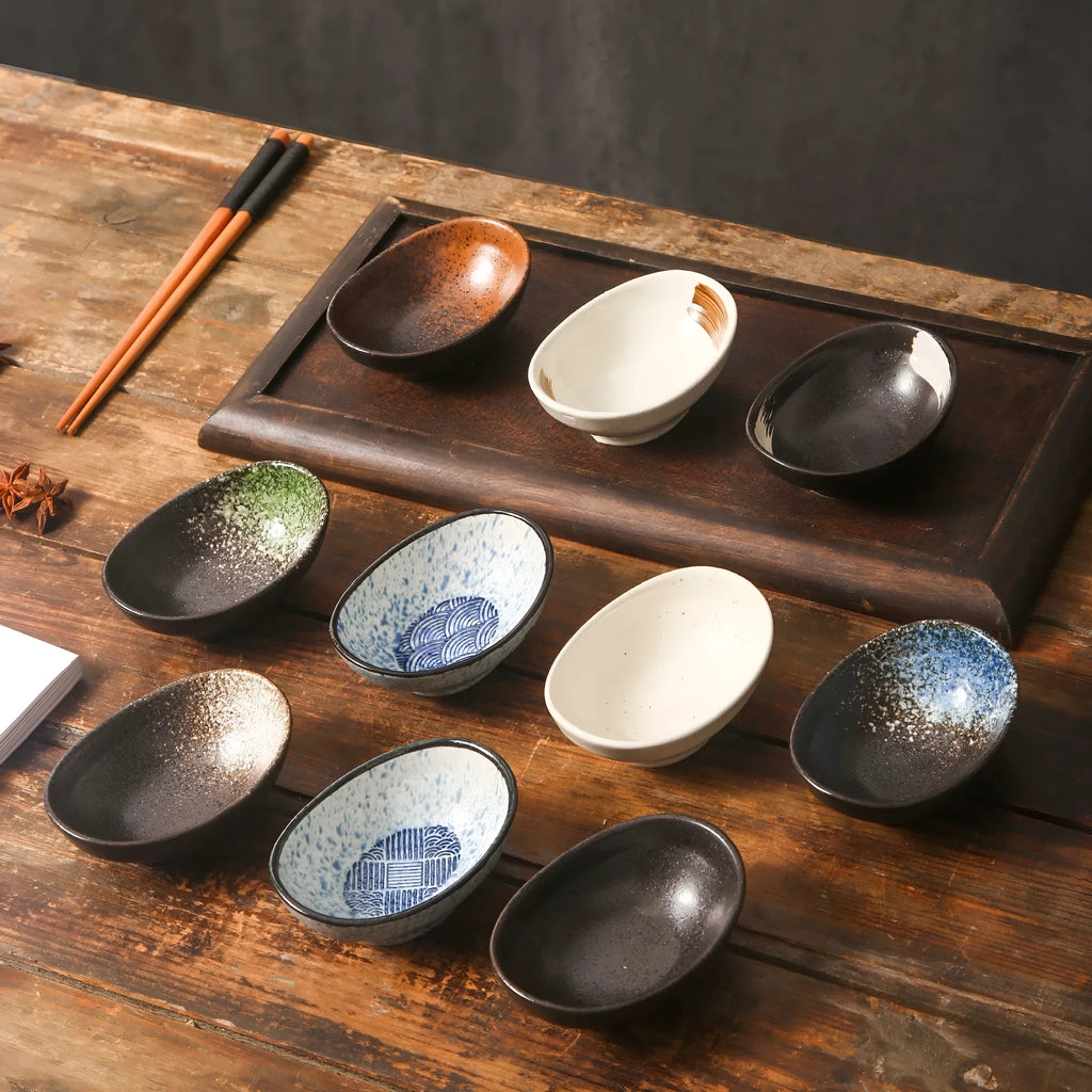 Japanese ceramic oval sauce dipping bowl with traditional underglaze pattern on white background