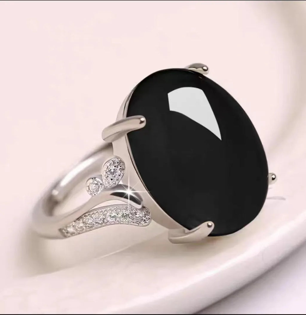 Geometric-style adjustable alloy ring in five colour options on a neutral background.