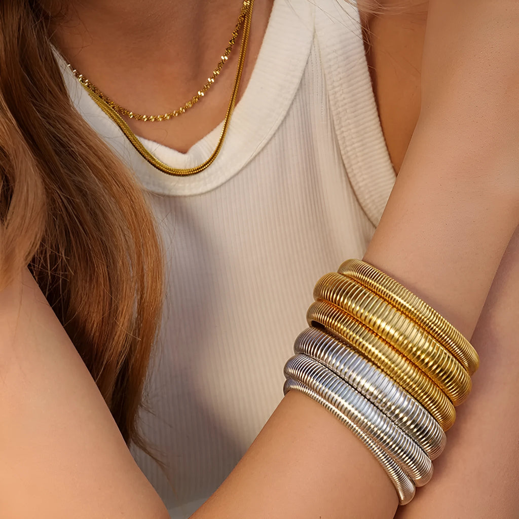 Women's elastic titanium steel bracelet with vertical stripe ring pattern in gold electroplated finish