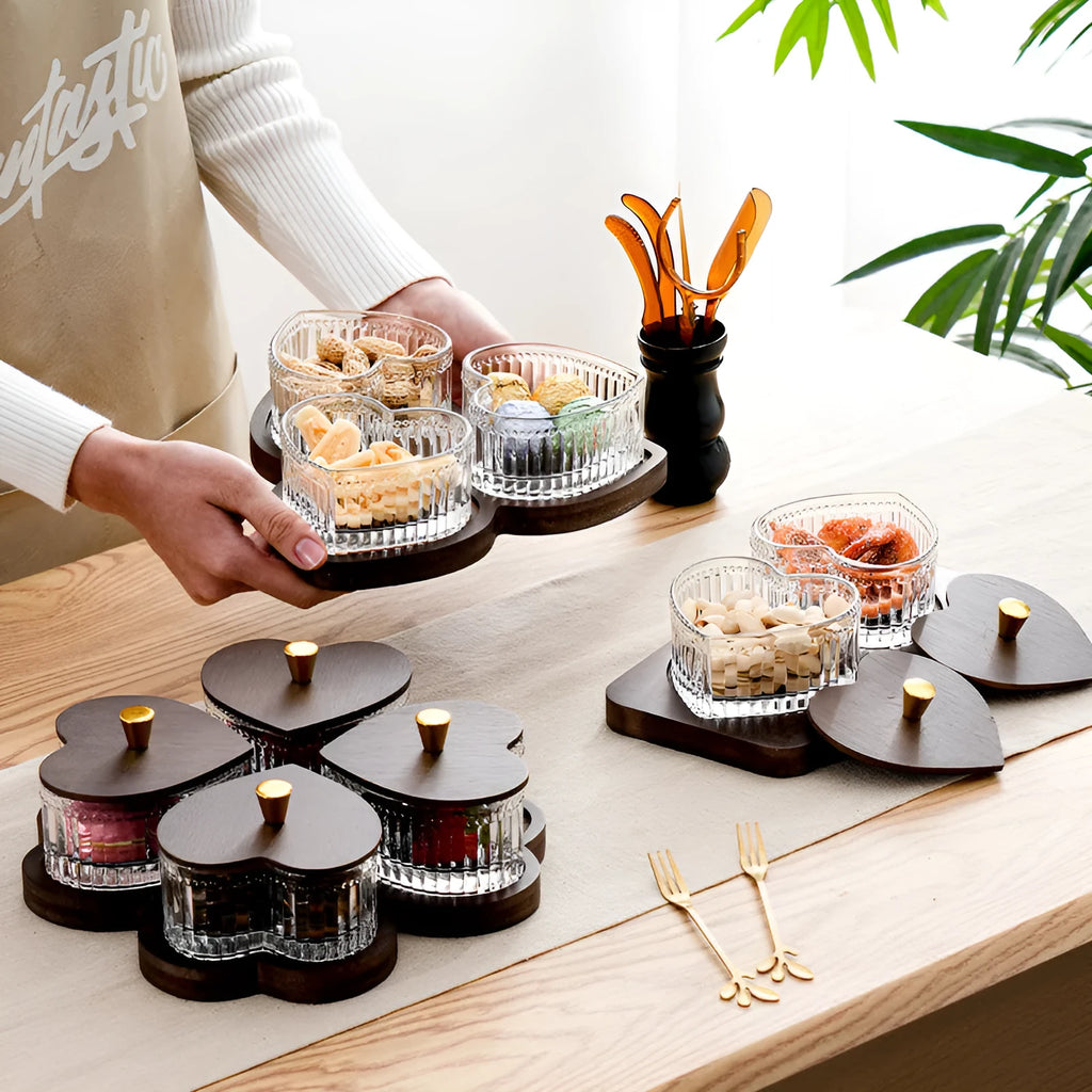 Transparent heart-shaped glass snack plate with multiple compartments and lids for organised food serving