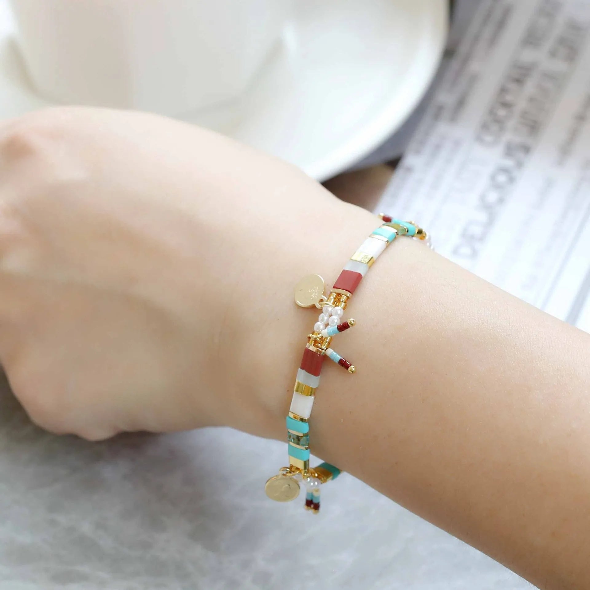 Women's imitation pearl beaded bracelet with glass coloured beads in six pearl lifting colour options