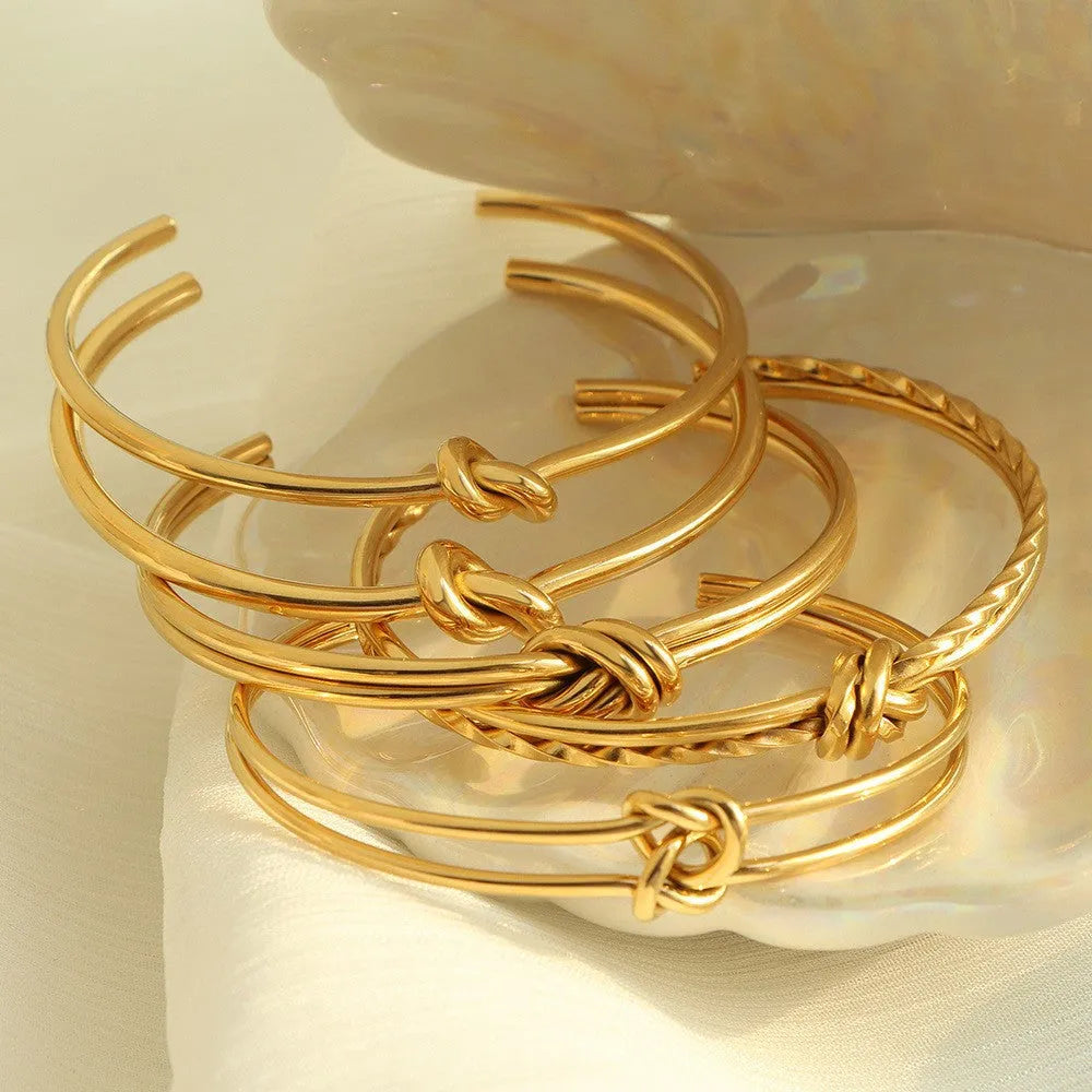 Women's adjustable knotted C-shaped open double-layer bracelet in gold or silver plated stainless steel.