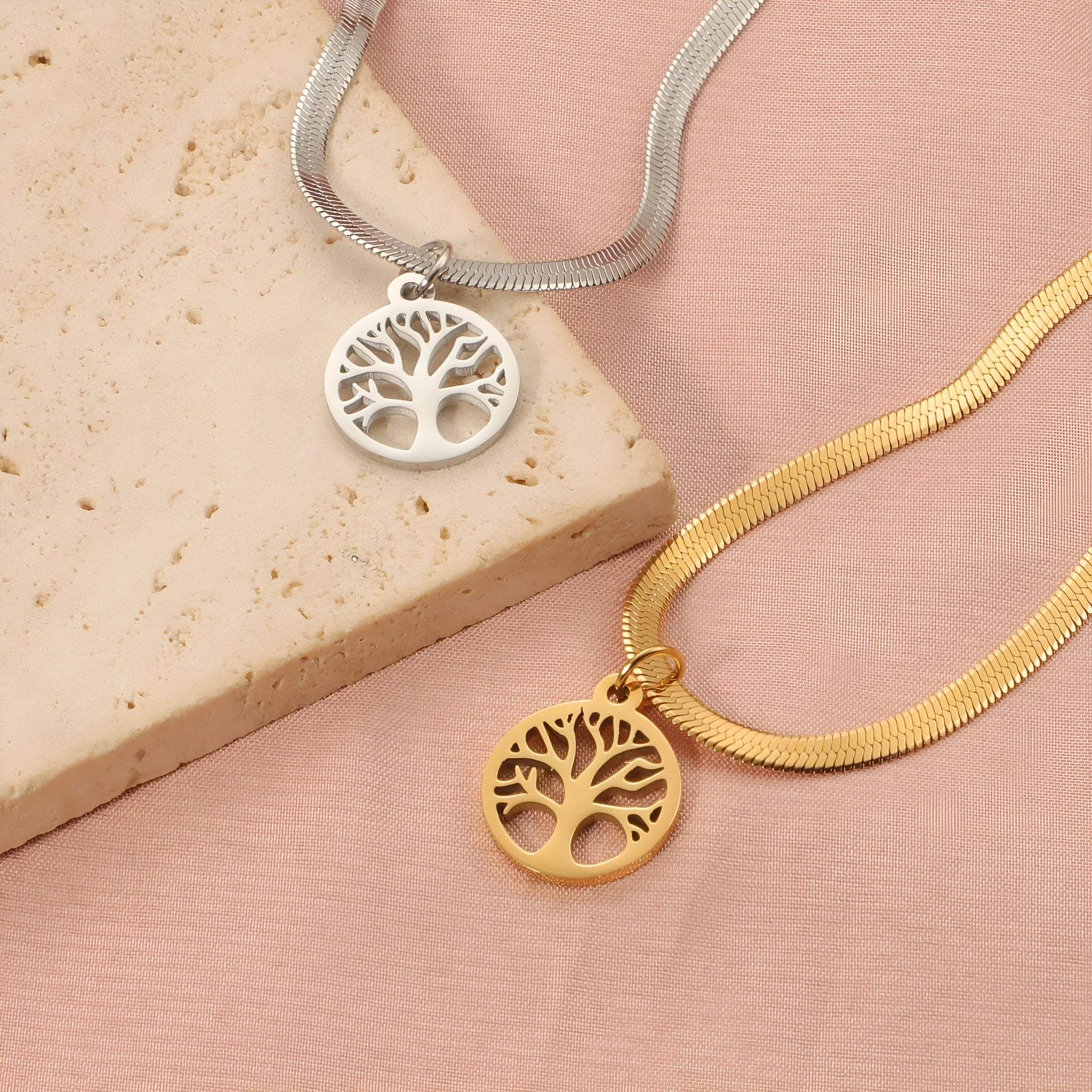 Stainless steel tree pendant necklace on a textured snake bone chain, shown in gold colour.