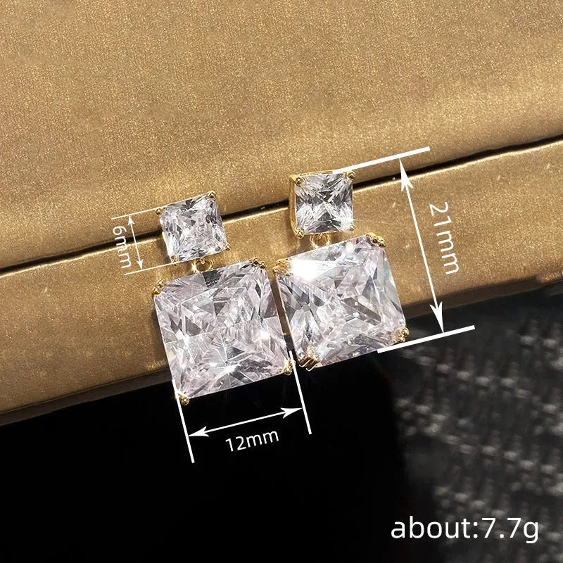 A pair of geometric square copper earrings for women, shown in white gold and gold colour finishes.