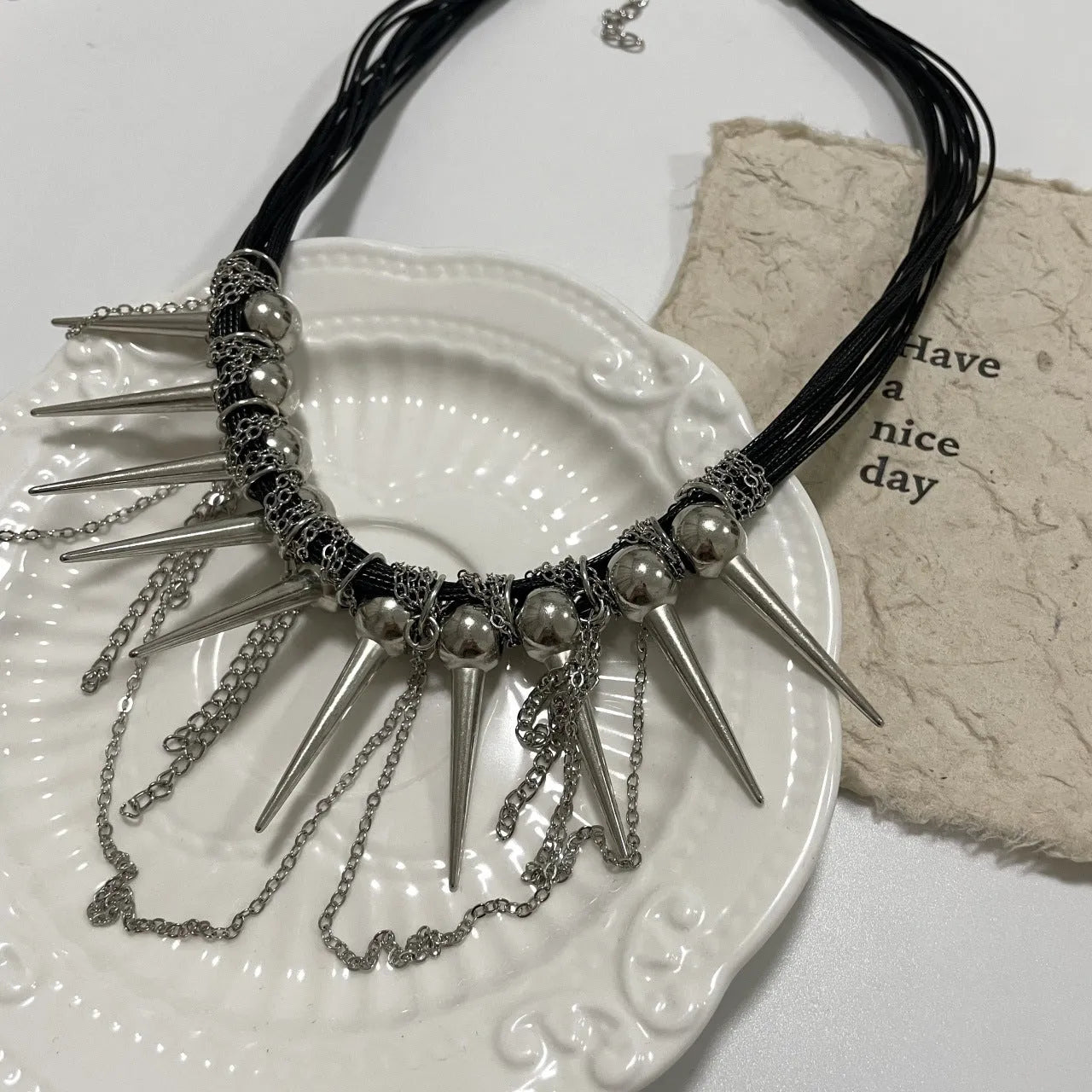 Women's leather necklace with electroplated round beads and a tassel drop in a casual, winding design.