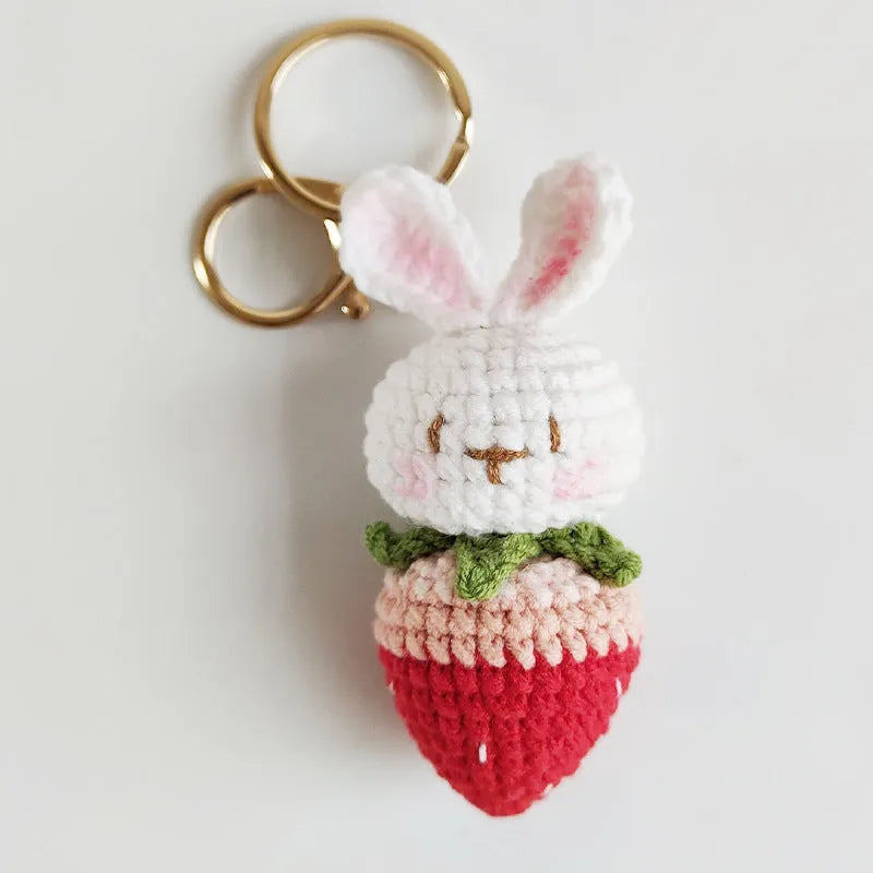 Hand-woven white doll wire pendant with cartoon rabbit and strawberry design on a key ring.