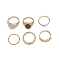 Six geometric alloy rings with light gold electroplated finish arranged irregularly