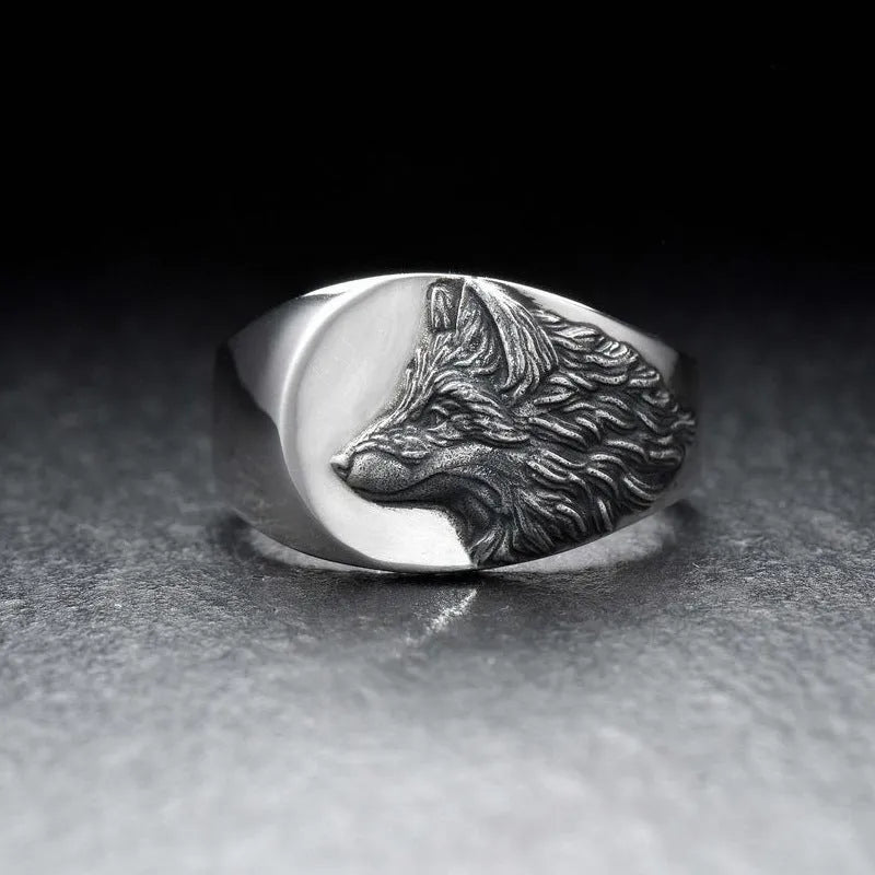 Men's silver geometric wolf head ring on a grey background showing detailed alloy construction.
