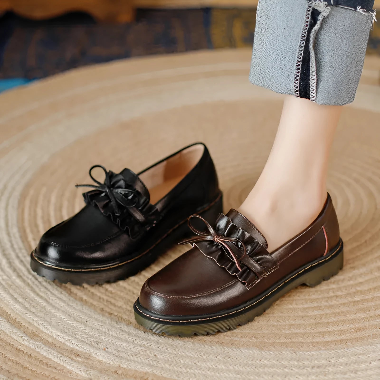 Black and brown women's round toe leather shoes with a chunky flat heel and low upper.