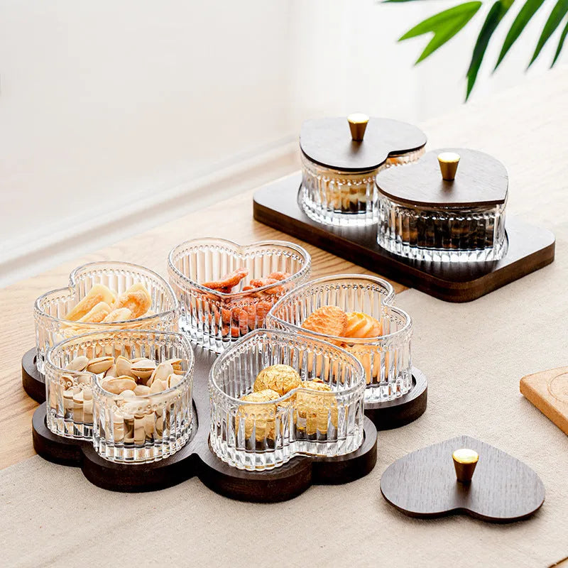 Transparent heart-shaped glass snack plate with multiple compartments and lids for organised food serving