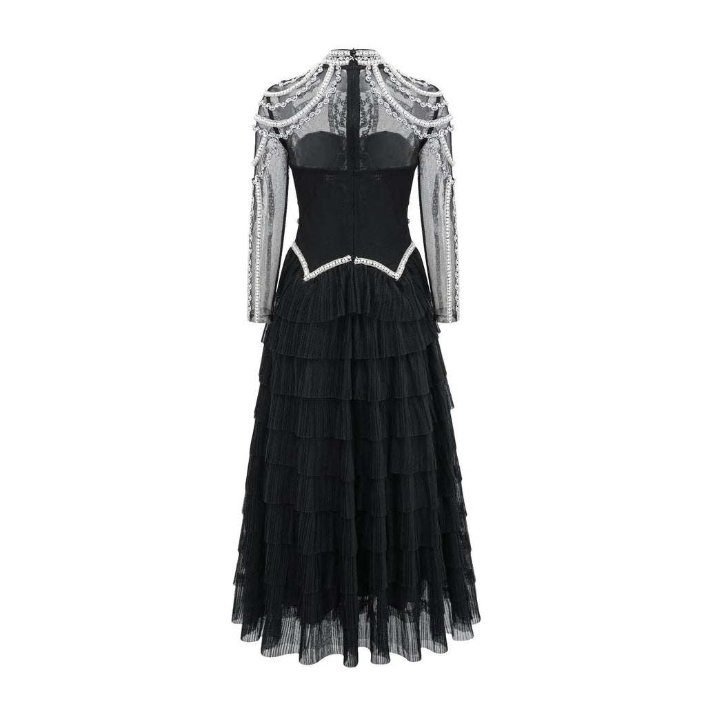 Black and pink women's long sleeve dress with beaded decoration on the front.
