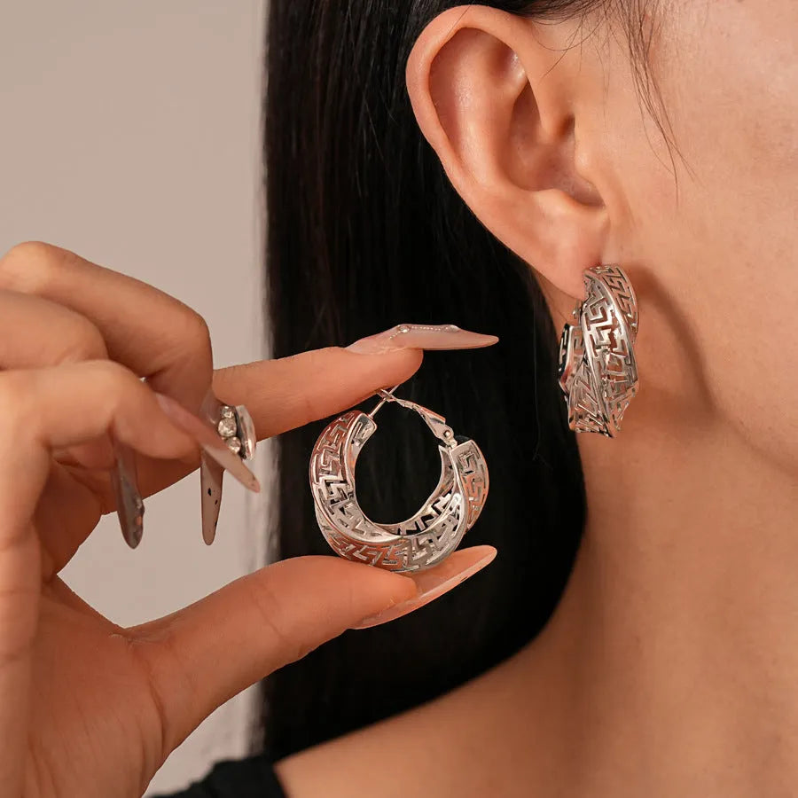 Women's geometric hollow stud earrings with twisted round design in gold and silver colour options